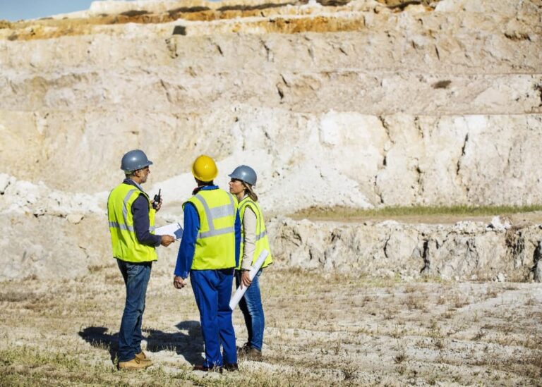 Three engineers in PPE talking